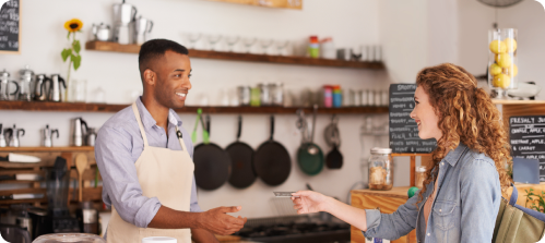 Customer completing a payment transaction at a food and beverage service counter.